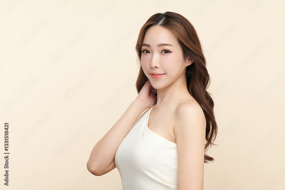 A beautiful young Asian woman with clean, fresh skin against a beige background. She represents beauty, skincare, and spa treatments. A beautiful young Asian woman with clean, fresh skin against a beige background. She represents beauty, skincare, and spa treatments.