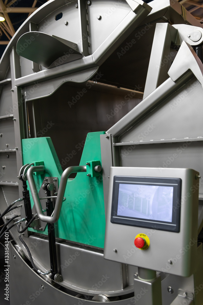 Fototapeta premium Side view of empty clean metal automated slaughter box in modern slaughterhouse or in meat packing plant. Food processing factory. Food and drink industry theme. Copy space.