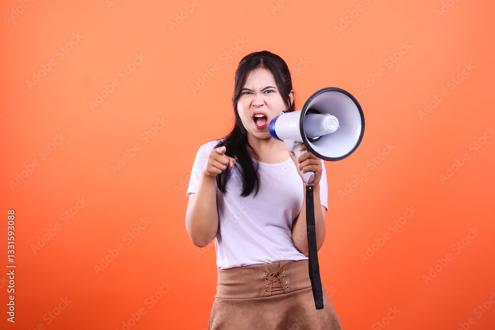 Person using megaphone against orange background with intense expression, pointing Person using megaphone against orange background with intense expression, pointing