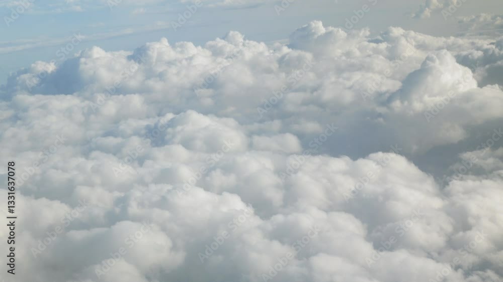 blue sky with white fluffy clouds from airplane flight fly over the clouds in a sunny day with cloud moving in summer, summer cloudscape background blue sky with white fluffy clouds from airplane flight fly over the clouds in a sunny day with cloud moving in summer, summer cloudscape background