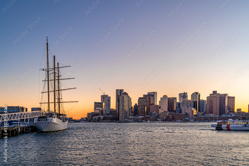 Naklejka premium View of Boston skyline and skyscrapers in late evening of February winter seen from Piers Park in Boston, MA