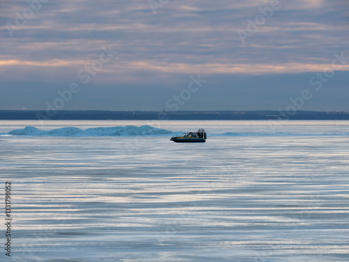 An amphibious hovercraft rushes across the ice of the Gulf of Finland, Russia photo