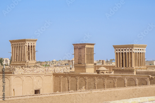 View from roof on the wind towers in the old city of Yazd, Iran. These towers serve to ventilate buildings and cool the air inside. They are also symbol of Yazd. Local name for the tower is badgir
