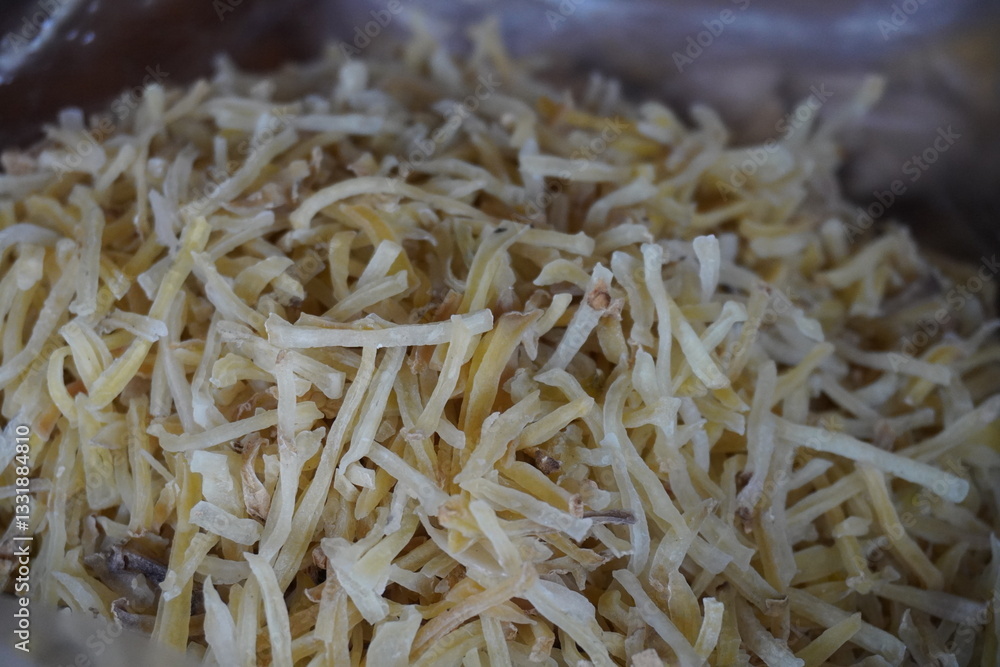 Aloo Lachha, a popular Indian snack made from thinly sliced and fried potatoes which is known for its crispy texture and savory taste, often seasoned with spices Aloo Lachha, a popular Indian snack made from thinly sliced and fried potatoes which is known for its crispy texture and savory taste, often seasoned with spices