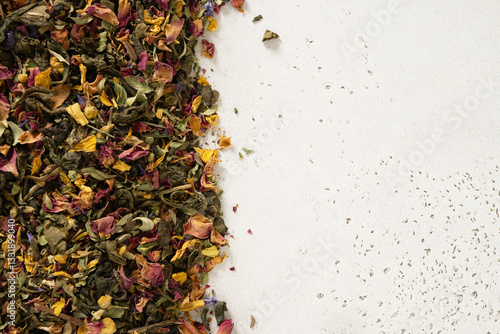 Obraz na płótnie Dry herbal tea and green tea as frame on white background. View from above. Copy space. Dry tea leaves texture. w salonie