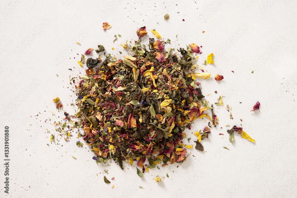 Pile of dry herbal tea and flowers green tea on white background. View from above. Dry tea leaves texture.