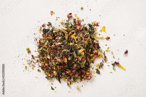 Obraz na płótnie Pile of dry herbal tea and flowers green tea on white background. View from above. Dry tea leaves texture. w salonie