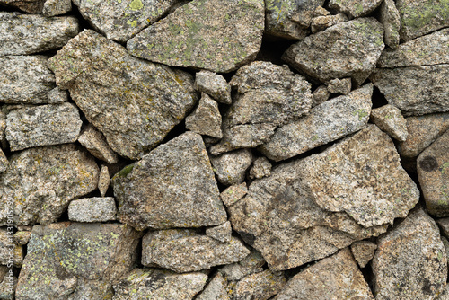 Obraz na płótnie Granite stone wall, old construction. Concept: Construction, stone, wall, stone wall. w salonie