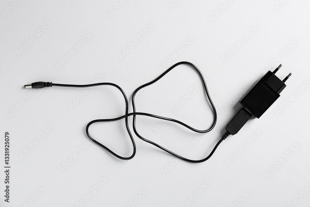 USB power adapter with charge cable on white background, top view USB power adapter with charge cable on white background, top view