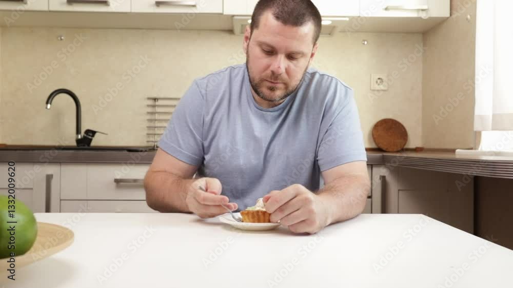 Man Eating Dessert, holding a spoon with a tasty pastry, enjoying a casual culinary moment. Man Eating Dessert, holding a spoon with a tasty pastry, enjoying a casual culinary moment.