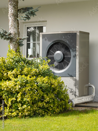 Obraz na płótnie Modern house with powerful heat pump on garden, efficient heating with green energy concept w salonie