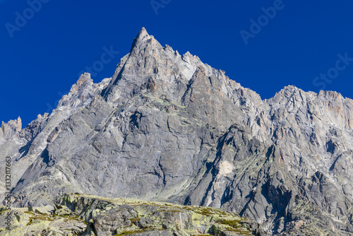 Aiguilles de Chamonix rocky granite mountain peaks in french Alps around Mont Blanc summit in Chamonix valley. Scenic landscape of iconic alpine summits the legends of mountaineering and alpinism