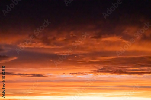 Vibrant sunrise sky with red and orange clouds