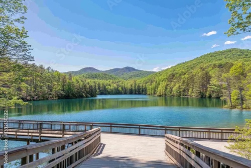 Serene Lake Beckons with Lush Greenery and Distant Mountains under Bright Sky