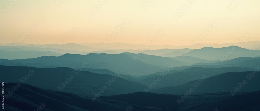 Obraz premium Layered mountain ranges stretch into the distance under a soft, pastel sky, creating a peaceful and infinite vista.
