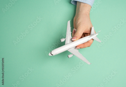 Passenger plane in hand. Air travel. Vacation planning, global mobility. Tourism, business trips, and exploring new destinations.