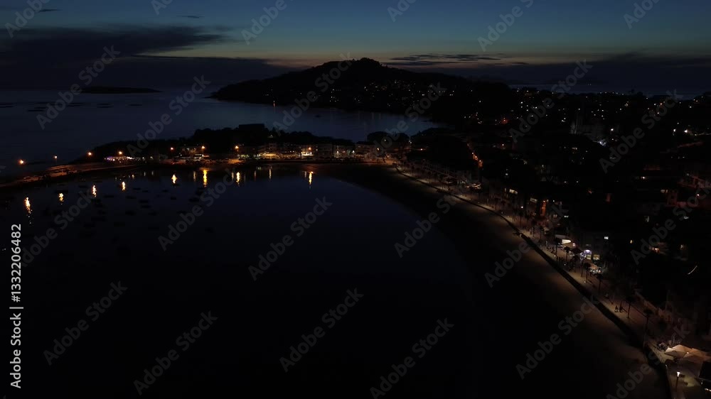 Descent over Panxón Beach during the blue hour, revealing the promenade lined with palm trees, the harbor with boats, Monteferro’s illuminated houses, and the Estelas and Cíes Islands on the horizon. Descent over Panxón Beach during the blue hour, revealing the promenade lined with palm trees, the harbor with boats, Monteferro’s illuminated houses, and the Estelas and Cíes Islands on the horizon.