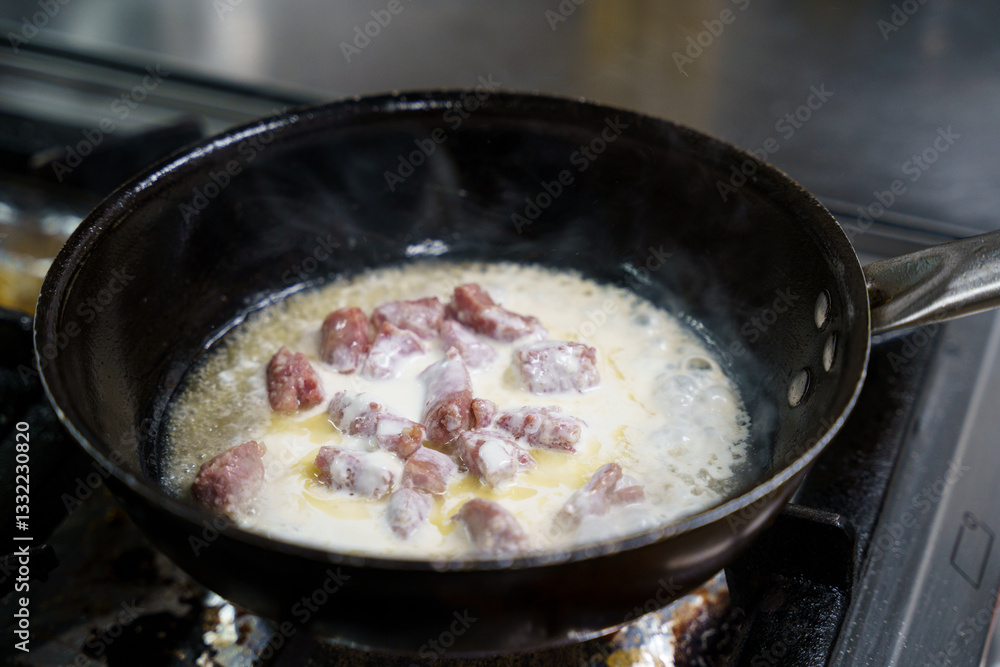 Cooking Meat in Cream Sauce on Stove Cooking Meat in Cream Sauce on Stove
