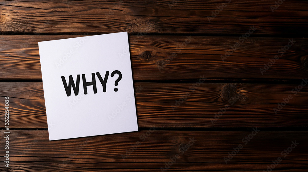 Why written in bold black letters on white paper against wooden background evokes curiosity and contemplation Why written in bold black letters on white paper against wooden background evokes curiosity and contemplation