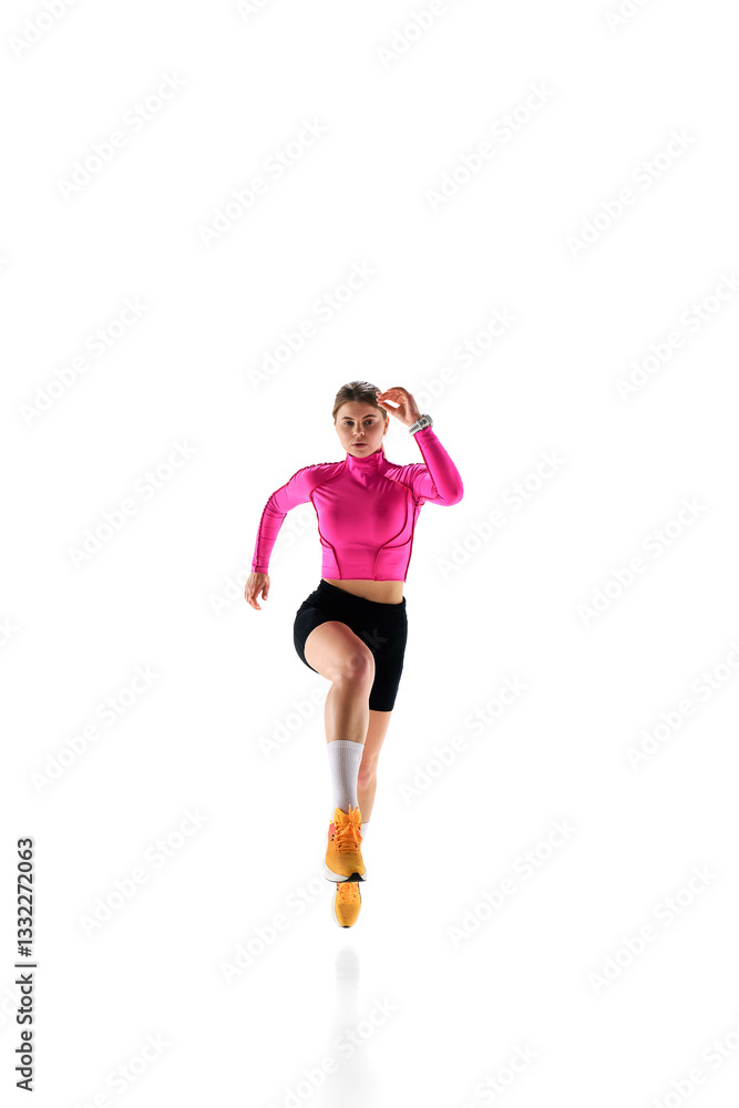 Front view of confident female runner in action, training hard, embodying endurance and ambition against white studio background. Concept of athletics, sport, endurance, fitness, healthy lifestyle. Ad Front view of confident female runner in action, training hard, embodying endurance and ambition against white studio background. Concept of athletics, sport, endurance, fitness, healthy lifestyle. Ad