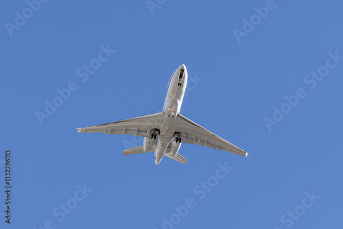 Commercial Airplane Flying Overhead Against a Clear Blue Sky