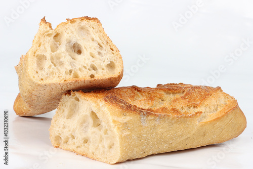 Baguette bread cut in half isolated on a white background