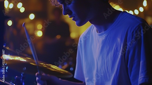 Obraz na płótnie Young male drummer performing passionately on stage in a vibrant music venue with ambient lighting and dynamic atmosphere, capturing energy and artistry w salonie