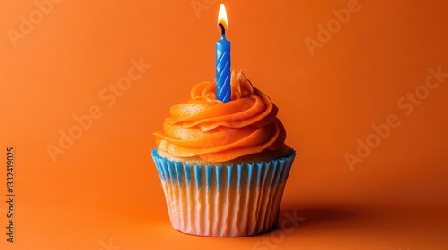 Fifth blue candle on orange birthday cupcake