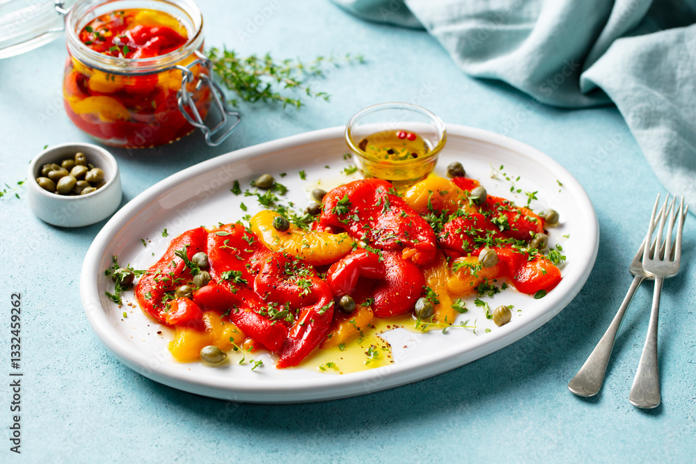 Marinated yellow and red bell pepper salad with capers and olive oil. Blue background. Close up. Marinated yellow and red bell pepper salad with capers and olive oil. Blue background. Close up.