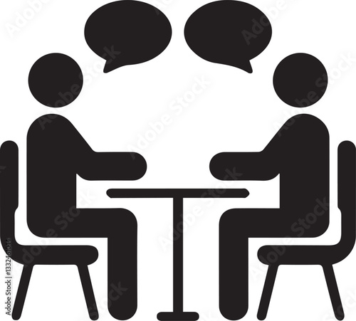 Two people sitting at a table engaged in conversation