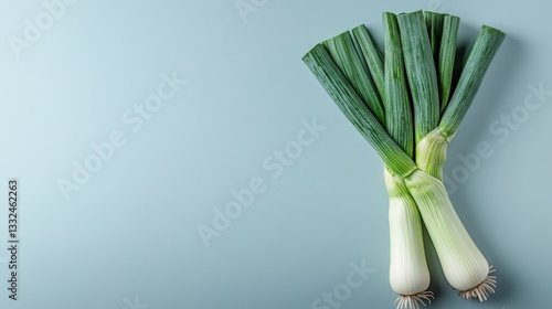 Fresh leeks on a blue background.