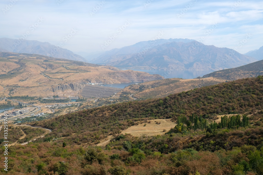 Fototapeta premium panorama of the Charvak reservoir, dam and mountains on the horizon, Uzbekistan