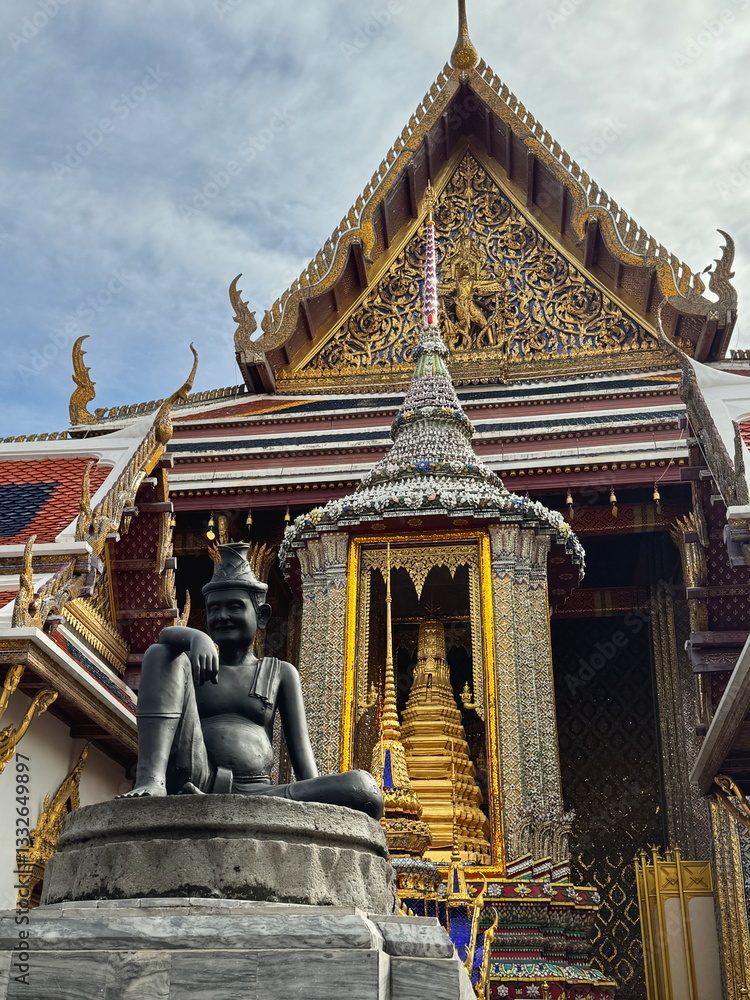 Beautiful ancient architecture of Thai temple with the statue of the hermit in Grand Palace in Bangkok