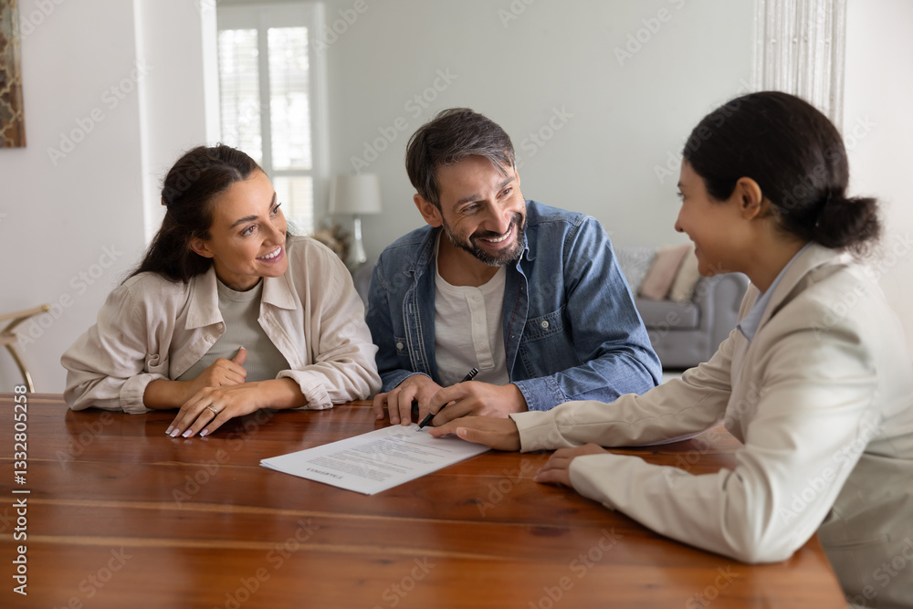 Happy husband and wife meeting with realtor, financial broker, adviser, signing legal paper document, buying property, house. Real estate agent pointing at place for buyer signature in agreement Happy husband and wife meeting with realtor, financial broker, adviser, signing legal paper document, buying property, house. Real estate agent pointing at place for buyer signature in agreement