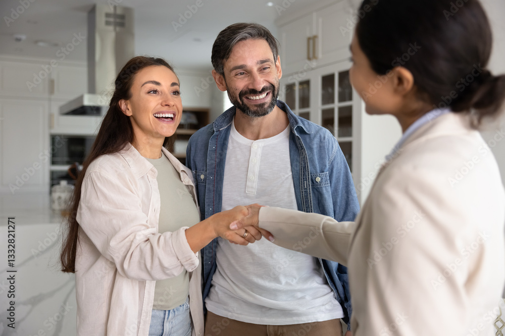 Fototapeta premium Accommodation rent agent and couple of tenant shaking hands in apartment, smiling, laughing, closing successful real estate deal. Happy homeowners thanking realtor with handshake