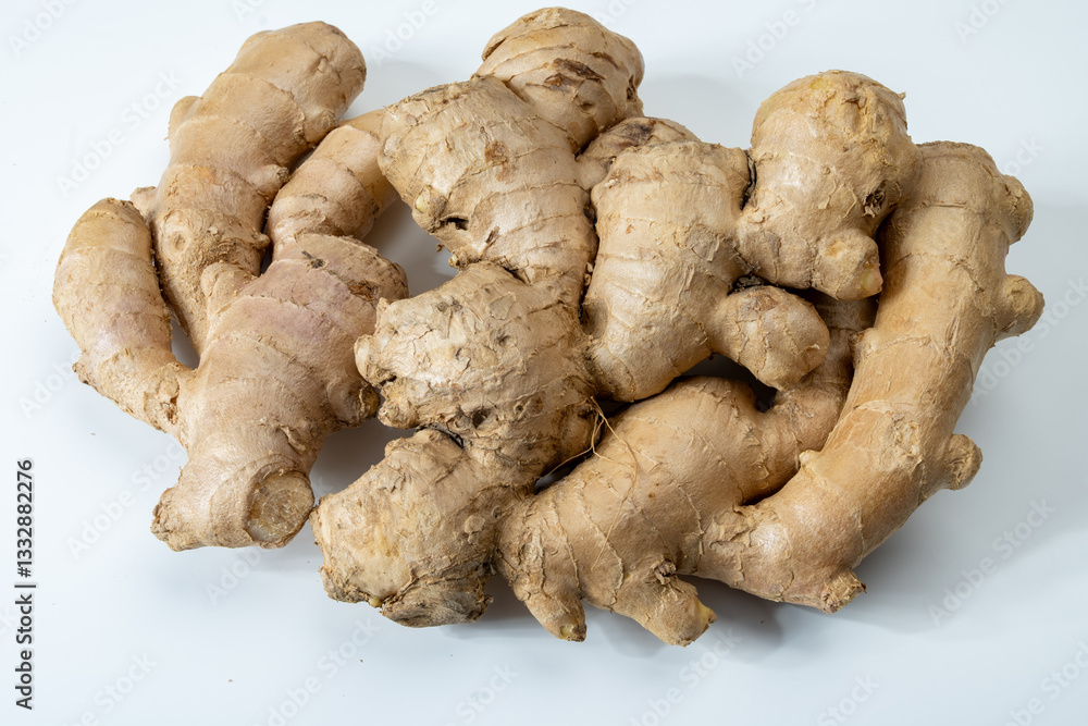 Fresh organic ginger rhizome root used in traditional medicines and for flavoring meals, drinks, isolated on white Fresh organic ginger rhizome root used in traditional medicines and for flavoring meals, drinks, isolated on white