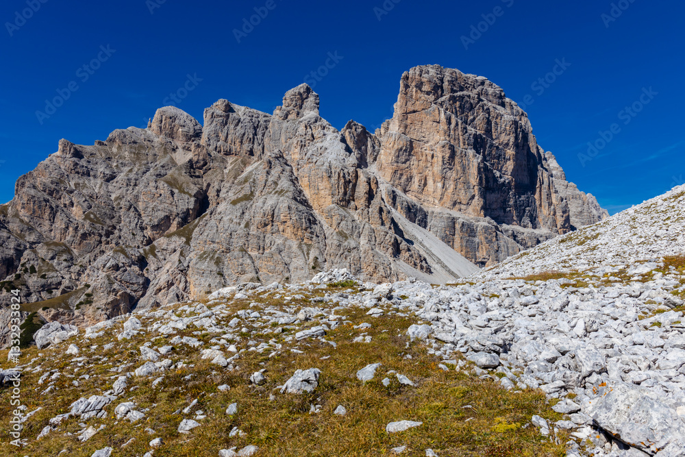 Dolomite Alps mountains in Europe beautiful landscape photo. Stunning rocky peaks of Dolomiti Alps under clear blue sky cliffs and climbing walls of European Alps scenic view Dolomite Alps mountains in Europe beautiful landscape photo. Stunning rocky peaks of Dolomiti Alps under clear blue sky cliffs and climbing walls of European Alps scenic view