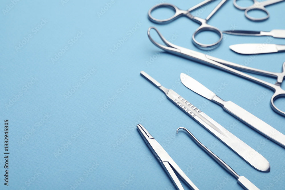 Different surgical tools on light blue background, closeup. Space for text Different surgical tools on light blue background, closeup. Space for text
