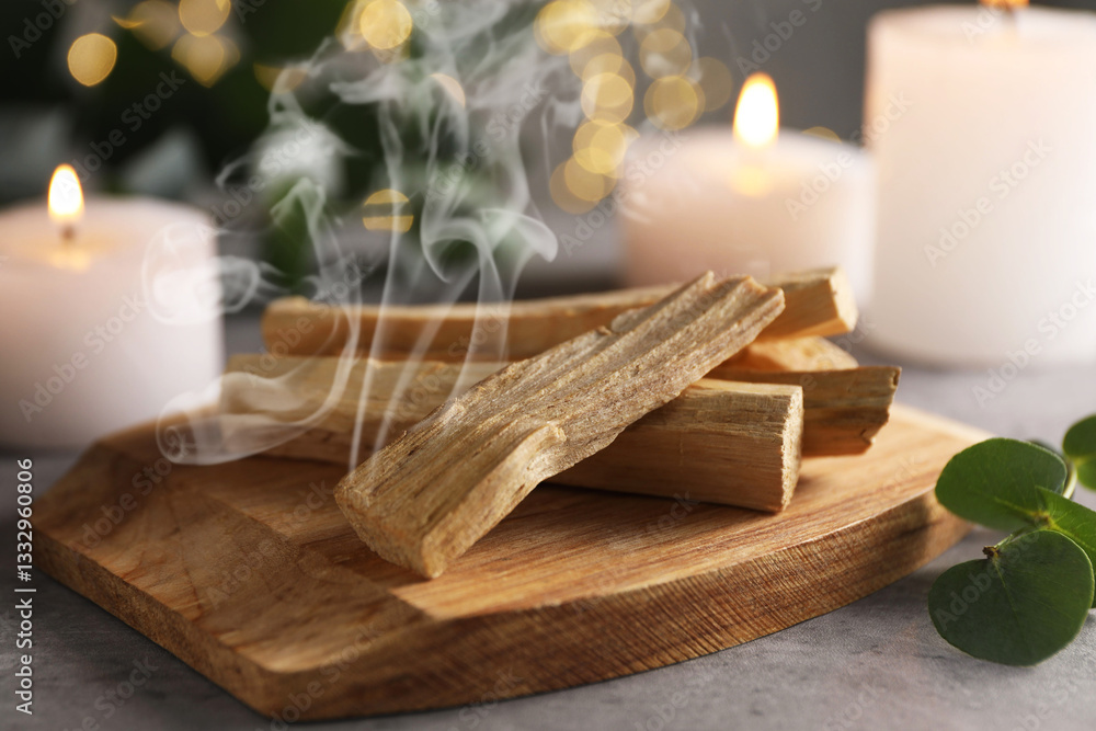 Palo Santo stick smoldering on grey table, closeup Palo Santo stick smoldering on grey table, closeup