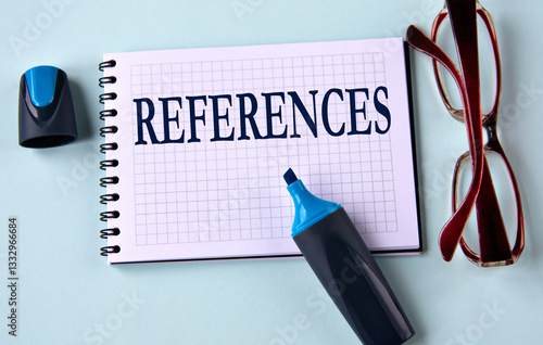 REFERENCES - word on a white sheet with glasses and marker in the background
