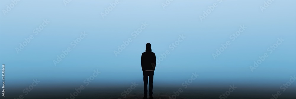 A lone figure stands in the distance, shrouded in misty ambiance, representing isolation, contemplation, and introspection in a serene yet haunting environment.