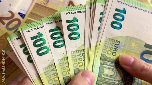 Counting euro banknotes. Female hands count 100 euros cash. Investments, family budget and savings concept	
