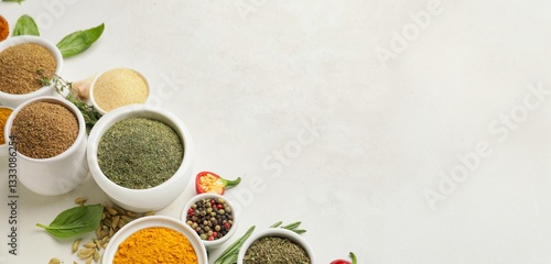 Fototapeta Naklejka Na Ścianę i Meble -  Bowls with different spices on light background with space for text