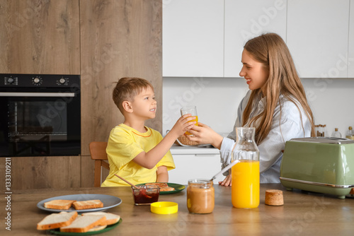 Mother giving juice to her ...