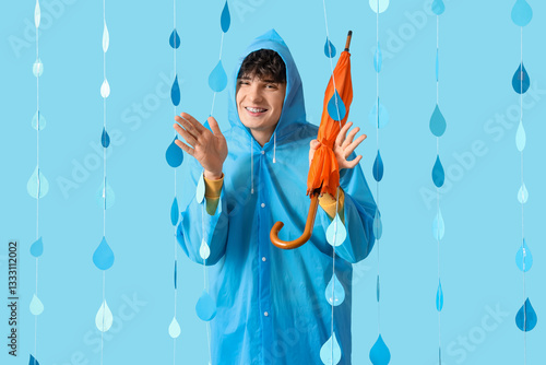 Young man in raincoat with ...