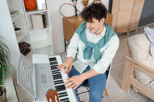 Male student playing synthe...