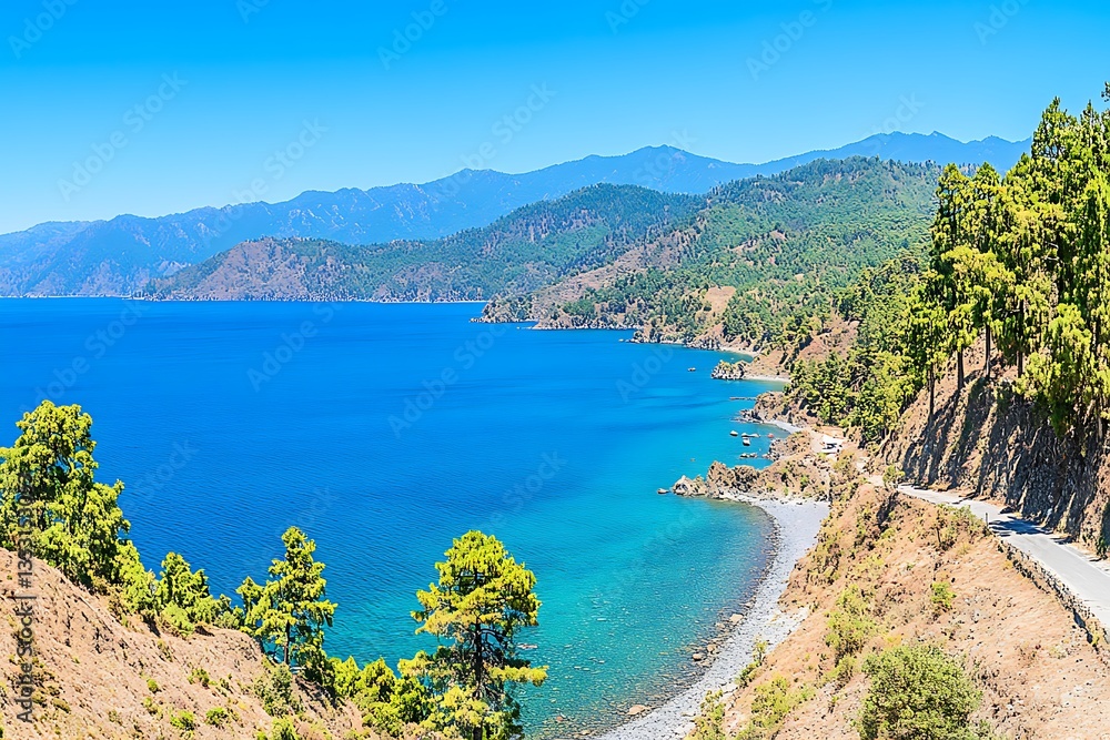 Fototapeta premium Serene Coastal Landscape with Turquoise Water and Mountains