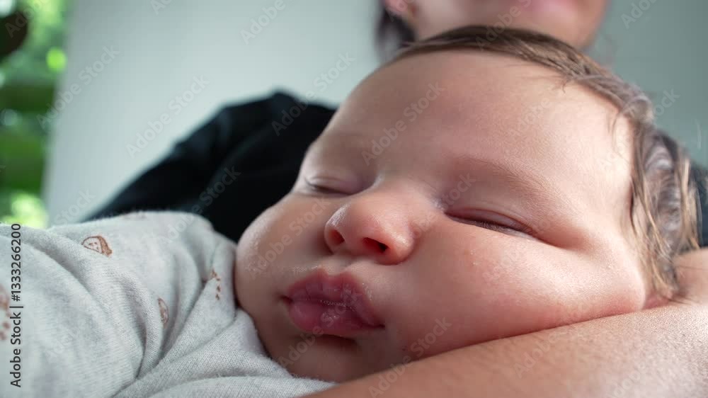 Baby peacefully asleep in mother’s arms, capturing a serene moment of rest in a nurturing home environment with soft, natural lighting Baby peacefully asleep in mother’s arms, capturing a serene moment of rest in a nurturing home environment with soft, natural lighting