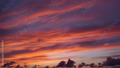 The sky is adorned with a breathtaking sunset, casting its glow over the clouds