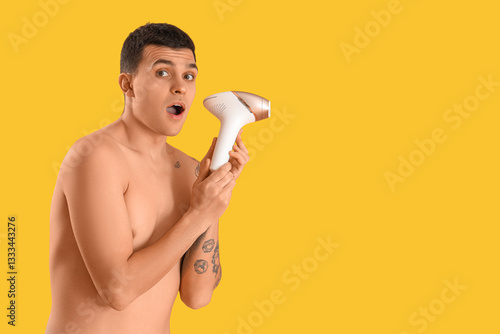 Surprised shirtless man hol...